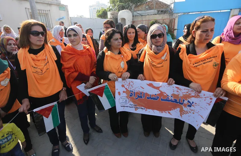 Palestinian women form a human chain during a rally to protest against the rising incidents of violence against women in Gaza City, on November 29, 2015. Photo by Mohammed Asad