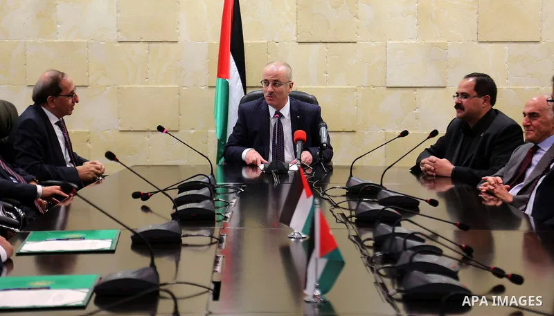 Palestinian Prime Minister Rami Hamdallah meets with Jordanian Minister of Education Labib Khadra, in the Wst Bank city of Ramallah on November 30, 2015. Photo by Prime Minister Office