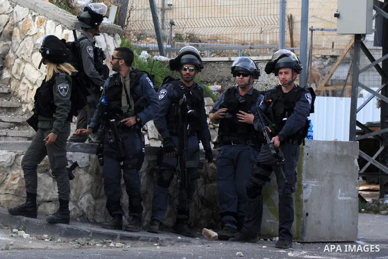 Palestinian protesters take part in clashes with Israeli security forces in Ras al-Amoud neighborhood, in Jerusalem against the killing of Palestinian teenager Ayman al-Abbasi on November 30, 2015. A 17-year-old Palestin...