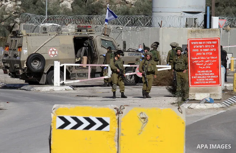Israeli security forces gather at the Einav checkpoint, east of Tulkarem in the occupied West Bank, where a young Palestinian woman was shot dead after reportedly seeking to stab a soldier on December 1, 2015. Palestinia...