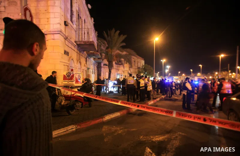 Israelis stand behind the police line near the scene following a stabbing attack near Jerusalem's Old City on December 3, 2015. A Palestinian attacker stabbed and wounded an Israeli policeman near Jerusalem's Old City be...