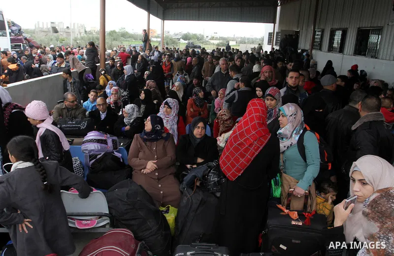 Palestinians wait for travel permits to cross into Egypt at the Rafah border crossing between Egypt and the southern Gaza Strip December 4, 2015. Egypt opened the Rafah border crossing on Thursday for two days to allow P...