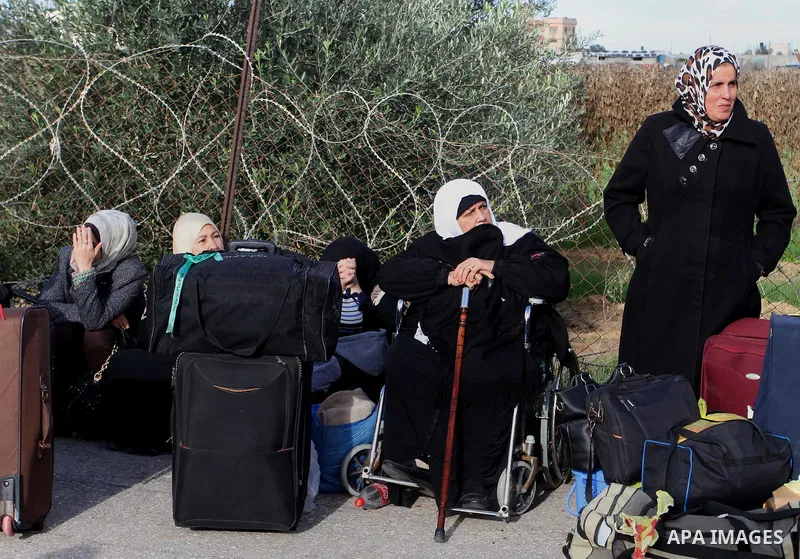 Palestinians wait for travel permits to cross into Egypt at the Rafah border crossing between Egypt and the southern Gaza Strip December 4, 2015. Egypt opened the Rafah border crossing on Thursday for two days to allow P...