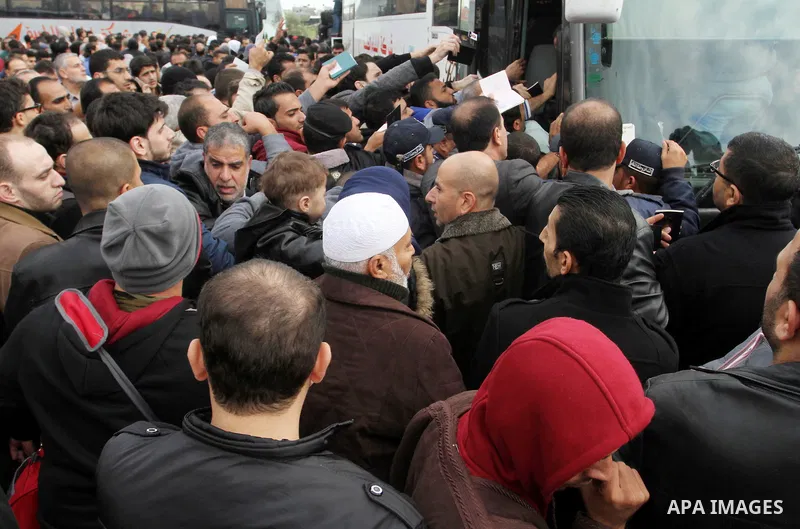 Palestinians try to get in a bus to cross into Egypt at the Rafah border crossing between Egypt and the southern Gaza Strip December 4, 2015. Egypt opened the Rafah border crossing on Thursday for two days to allow Pales...