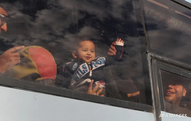 A Palestinian boy looks out a bus window as he waits with his family to cross into Egypt at the Rafah border crossing between Egypt and the southern Gaza Strip December 4, 2015. Egypt opened the Rafah border crossing on...