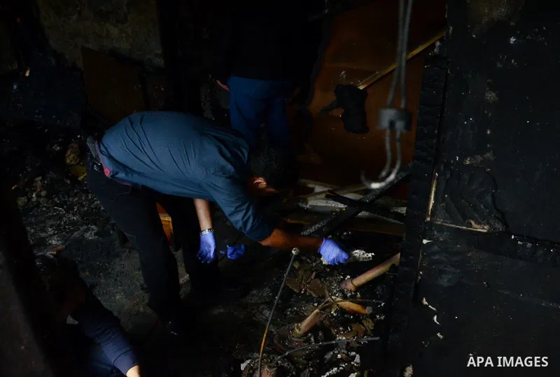 A forensic investigator inspects the scene of a Cairo disco where a petrol bomb attack took place in the Agouza neighbourhood of the Egyptian capital's Giza district on December 4, 2015. At least 16 people were killed an...