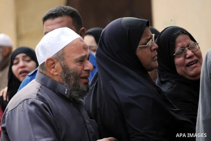 Relatives mourn for victims of a petrol bomb attack on a Cairo disco in the Agouza neighbourhood of the Egyptian capital's Giza district on December 4, 2015. At least 16 people were killed and two wounded in the early mo...