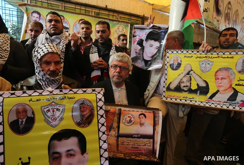 Palestinians take part in a protest demanding release the prisoners in Israeli jails, in front of Red cross office, in Gaza city, on Dec. 07, 2015. Photo by Mohammed Asad