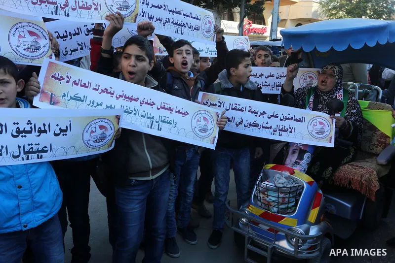 Palestinians take part in a protest demanding release the prisoners in Israeli jails, in front of Red cross office, in Gaza city, on Dec. 07, 2015. Photo by Mohammed Asad