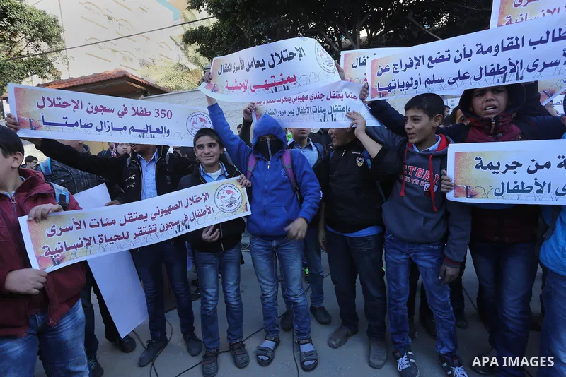 Palestinians take part in a protest demanding release the prisoners in Israeli jails, in front of Red cross office, in Gaza city, on Dec. 07, 2015. Photo by Mohammed Asad