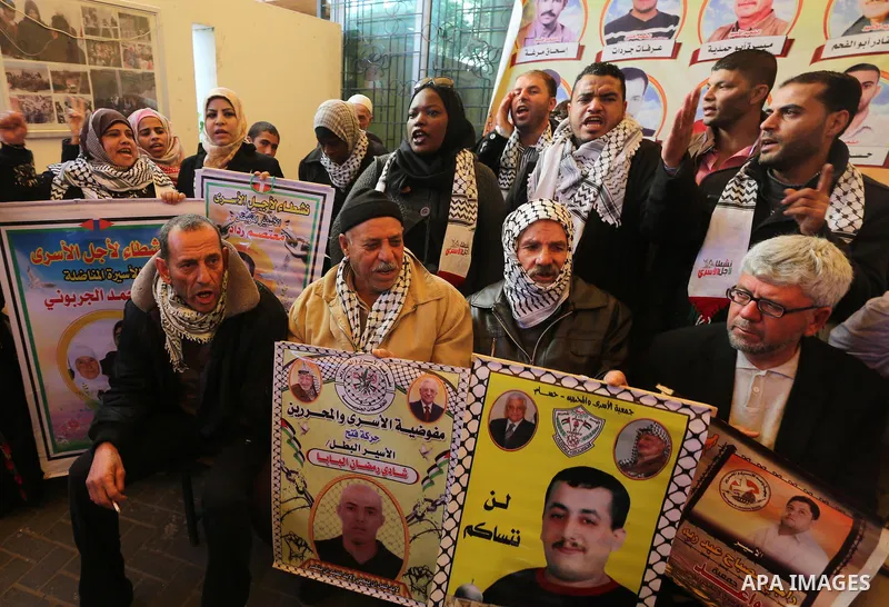 Palestinians take part in a protest demanding release the prisoners in Israeli jails, in front of Red cross office, in Gaza city, on Dec. 07, 2015. Photo by Mohammed Asad