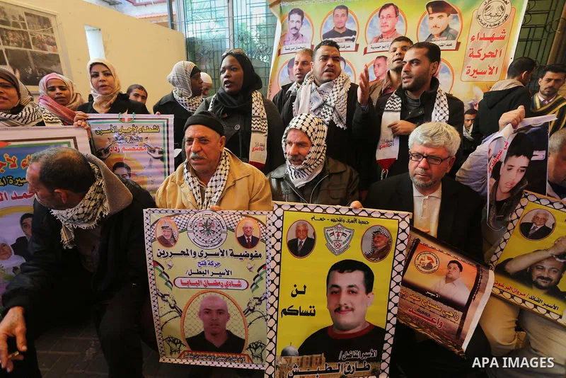 Palestinians take part in a protest demanding release the prisoners in Israeli jails, in front of Red cross office, in Gaza city, on Dec. 07, 2015. Photo by Mohammed Asad