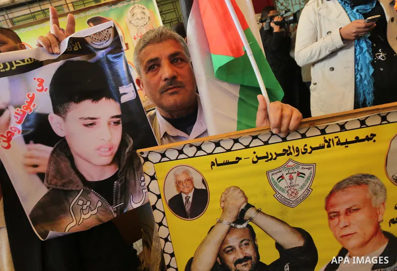 Palestinians take part in a protest demanding release the prisoners in Israeli jails, in front of Red cross office, in Gaza city, on Dec. 07, 2015. Photo by Mohammed Asad