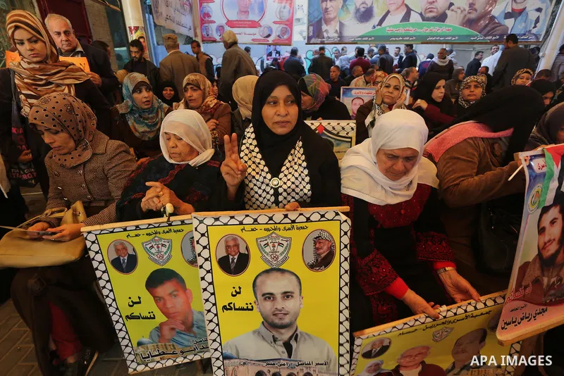 Palestinians take part in a protest demanding release the prisoners in Israeli jails, in front of Red cross office, in Gaza city, on Dec. 07, 2015. Photo by Mohammed Asad
