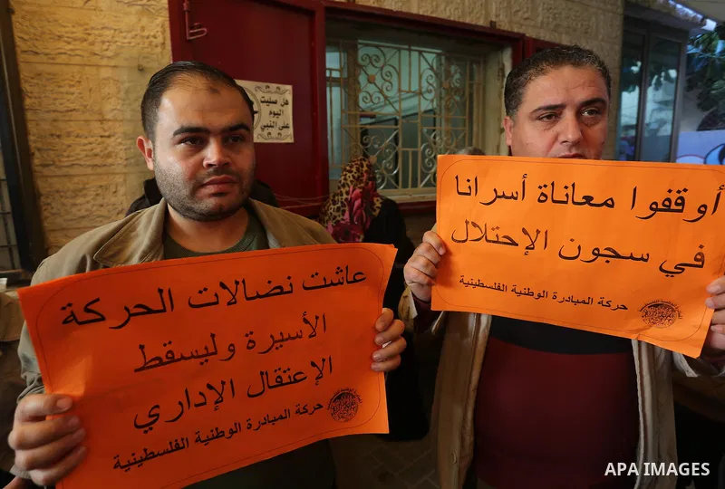 Palestinians take part in a protest demanding release the prisoners in Israeli jails, in front of Red cross office, in Gaza city, on Dec. 07, 2015. Photo by Mohammed Asad