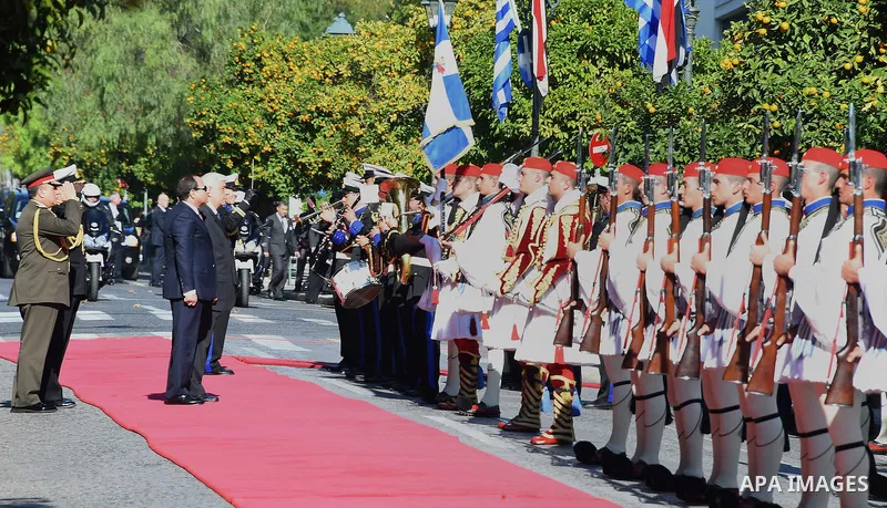 Egyptian President Abdel-Fattah al-Sisi and Greek President Prokopis Pavlopoulos review the honor guard during a welcome ceremony in Athens, Dec. 8, 2015. Egyptian President Abdel-Fattah al-Sisi arrived in Athens to atte...