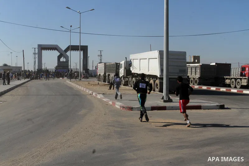Palestinian youths take part in a marathon organized by Hamas movement to mark anniversary of the founding Hamas and demanding the Egyptian authorities for the opening of the Rafah crossing in Rafah in the southern Gaza...