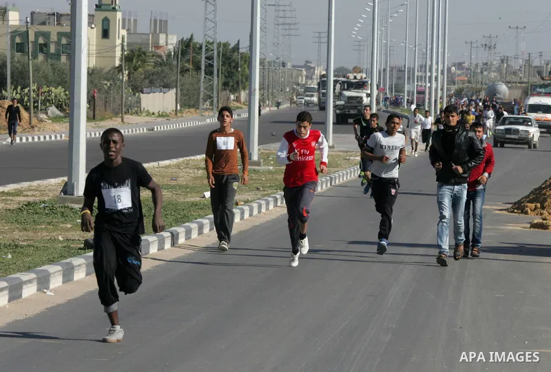 Palestinian youths take part in a marathon organized by Hamas movement to mark anniversary of the founding Hamas and demanding the Egyptian authorities for the opening of the Rafah crossing in Rafah in the southern Gaza...