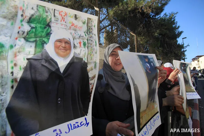 Palestinian take part during a protest to show solidarity with Palestinian prisoner Zeenat Jallad, 62, in occupied Jerusalem on Dec. 10, 2015. Photo by Mahfouz Abu Turk