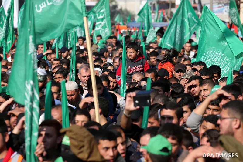 Palestinians attend a military parade of members of al-Qassam Brigades, the armed wing of the Hamas movement, to mark the 28th anniversary of the Islamist movements creation on December 11, 2015, in the Jabalia refugee c...