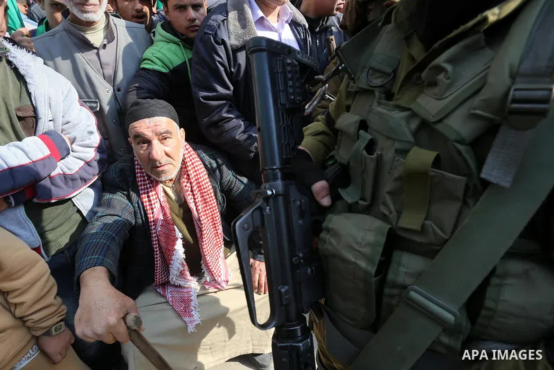 Palestinians attend a military parade of members of al-Qassam Brigades, the armed wing of the Hamas movement, to mark the 28th anniversary of the Islamist movements creation on December 11, 2015, in the Jabalia refugee c...