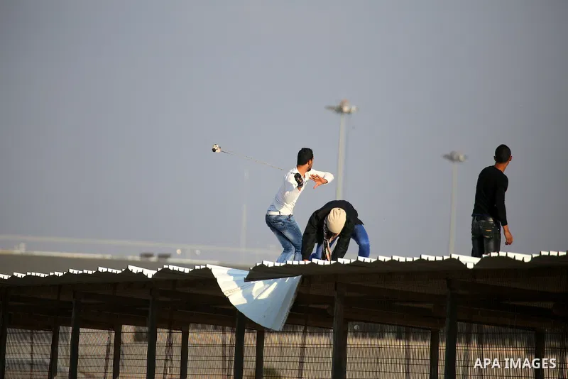Palestinian protesters clash with Israeli security forces at the Erez crossing checkpoint in the northern Gaza Strip on Dec. 11, 2015. A Palestinian was shot dead and 12 wounded in clashes with Israeli forces on the bord...