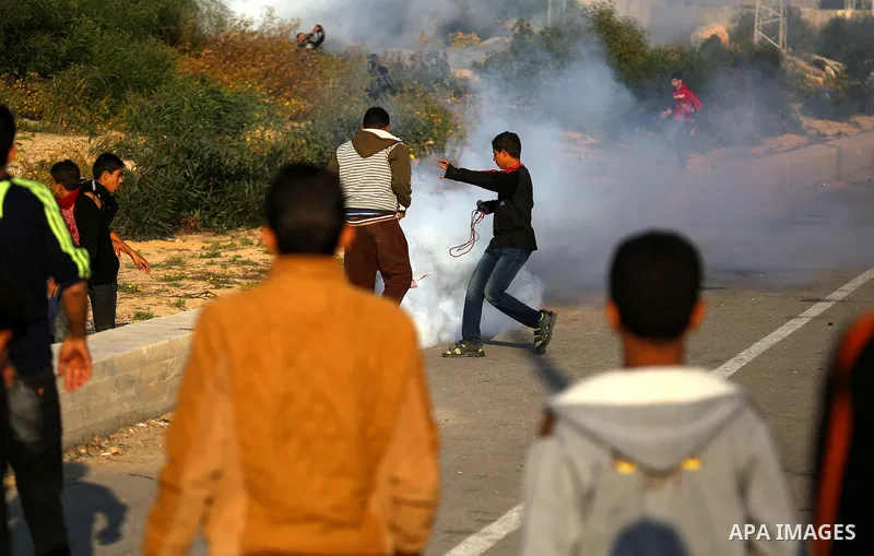 Palestinian protesters clash with Israeli security forces at the Erez crossing checkpoint in the northern Gaza Strip on Dec. 11, 2015. A Palestinian was shot dead and 12 wounded in clashes with Israeli forces on the bord...