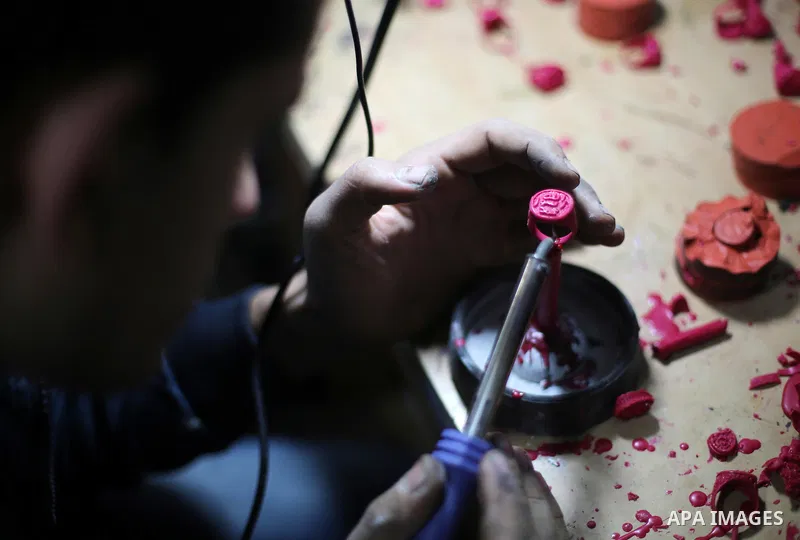 A Palestinian silver jeweler designs silver rings at his workshop in Gaza city on Dec. 16, 2015. Photo by Mohammed Asad