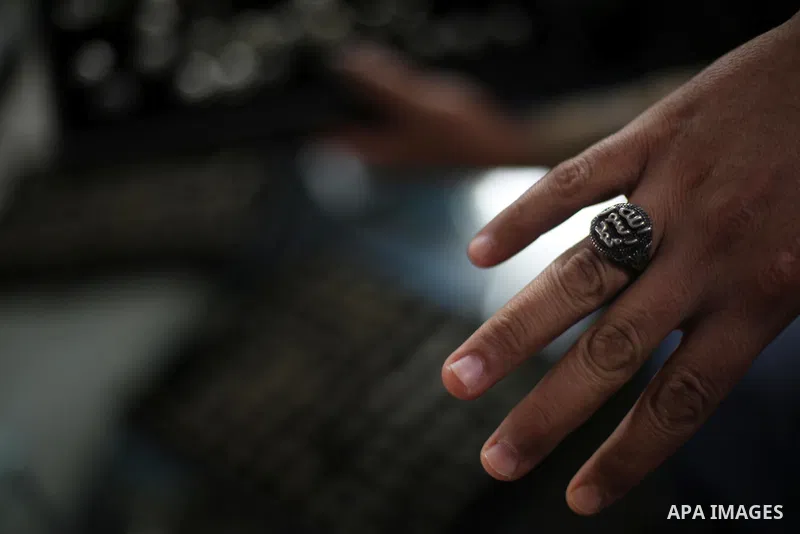 A Palestinian curator displays silver rings at his shop in Gaza city on Dec. 16, 2015. Photo by Mohammed Asad