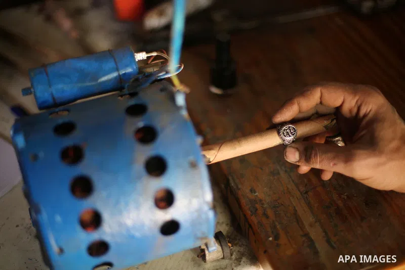 A Palestinian silver jeweler designs silver rings at his workshop in Gaza city on Dec. 16, 2015. Photo by Mohammed Asad