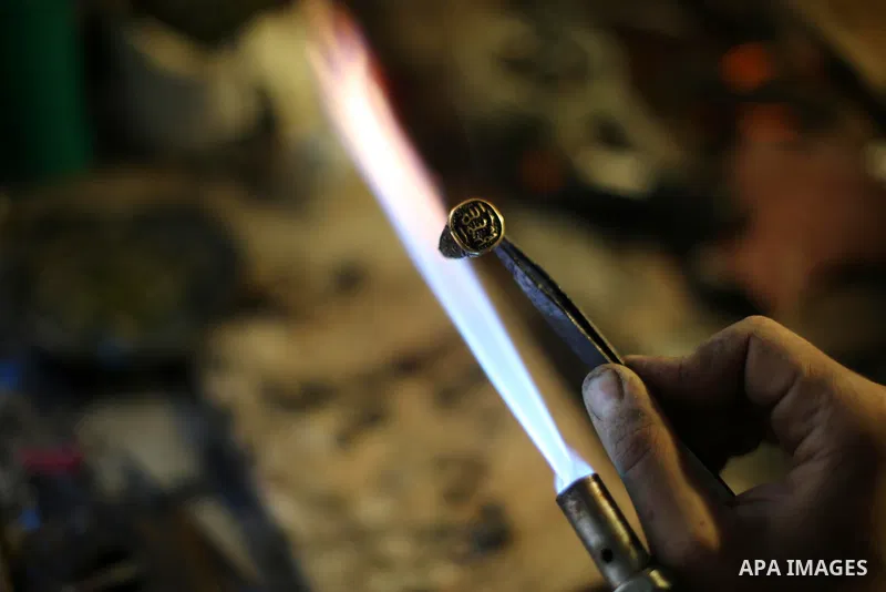 A Palestinian silver jeweler designs silver rings at his workshop in Gaza city on Dec. 16, 2015. Photo by Mohammed Asad