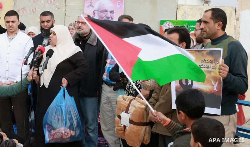 Relatives of Palestinian prisoners take part in a protest demanding to the entery of the winter clothing for their prisoners in Israeli jails, outside Eriz crossing in the northern Gaza Strip, on Dec. 17, 2015. Photo by...