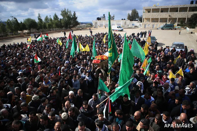 Mourners carry the body of Mahdiyah Hammad, a 38-year-old woman, who was shot dead by Israeli border guards after she tried to ram them with a car the day before, during her funeral in the occupied West Bank village of S...
