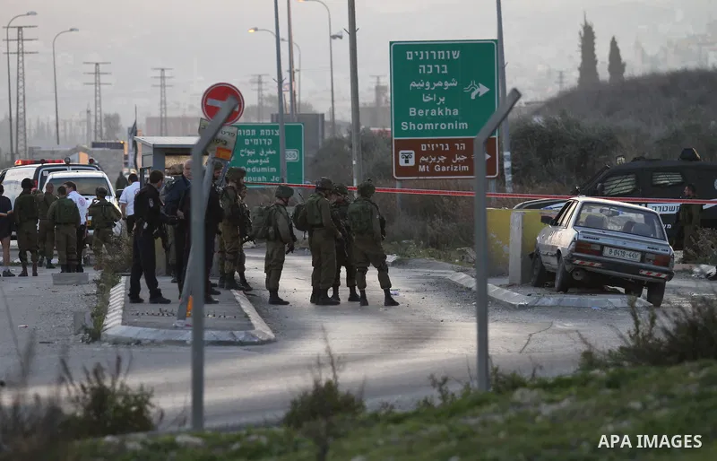Israeli security forces gather at the site of a car ramming attack at the Huwara checkpoint near the West Bank city of Nablus, on December 26, 2015. The Israeli army said a Palestinian driver approached the Huwara checkp...