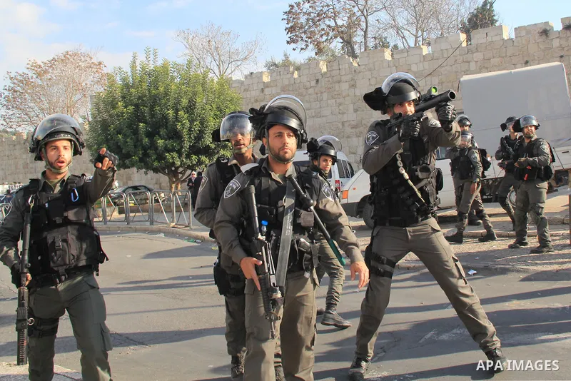 Israeli security forces stand guard and attempt to disperse Palestinian protesters outside Damascus Gate in Jerusalem's old city following a demonstration demanding Israeli authorities to return the bodies of alleged Pal...