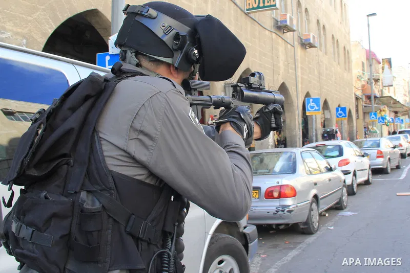 Israeli security forces stand guard and attempt to disperse Palestinian protesters outside Damascus Gate in Jerusalem's old city following a demonstration demanding Israeli authorities to return the bodies of alleged Pal...