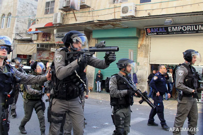Israeli security forces stand guard and attempt to disperse Palestinian protesters outside Damascus Gate in Jerusalem's old city following a demonstration demanding Israeli authorities to return the bodies of alleged Pal...