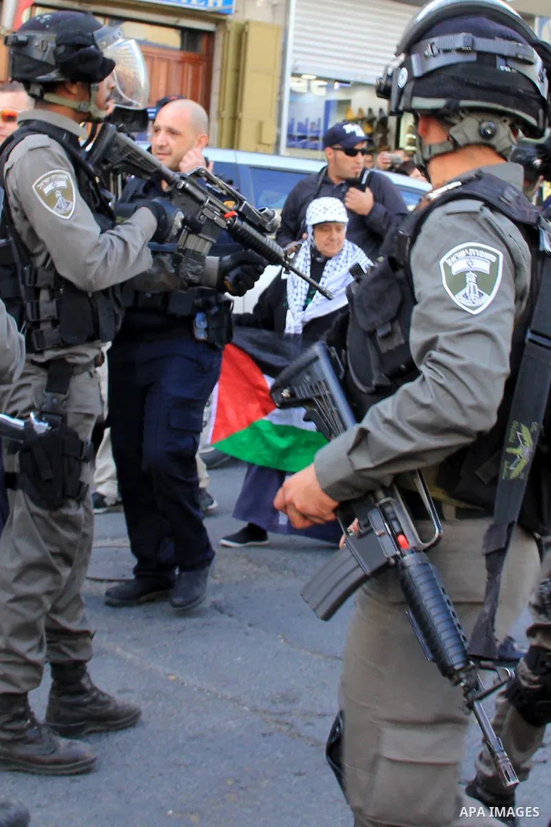 Israeli security forces stand guard and attempt to disperse Palestinian protesters outside Damascus Gate in Jerusalem's old city following a demonstration demanding Israeli authorities to return the bodies of alleged Pal...