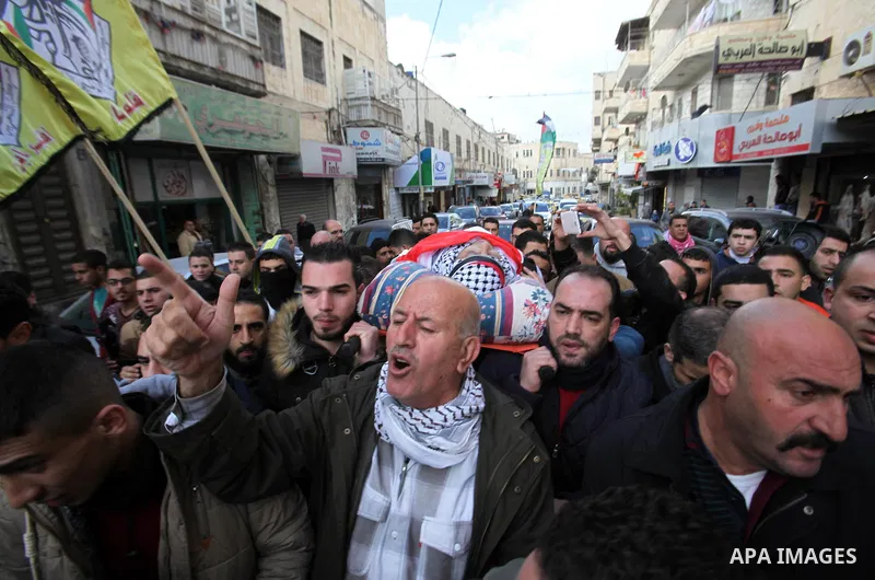 Mourners carry the body of Palestinian Baseem Salah, 38-year-old during his funeral in the West Bank city of Nablus on Dec. 30, 2015. Salah was killed Nov. 30 after an attack left an Israeli police officer wounded in Jer...