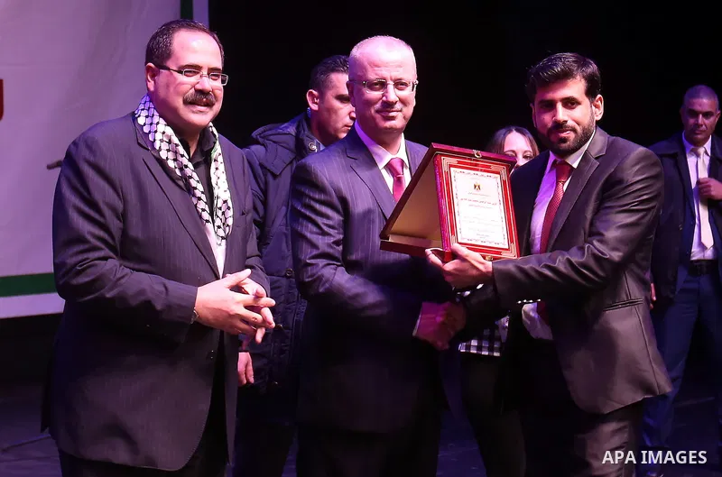 Palestinian Prime Minister Rami Hamdallah attends the Palestinian Teacher Day ceremony in the West bank city of Ramallah on Dec. 30, 2015. Photo by Prime Minister Office