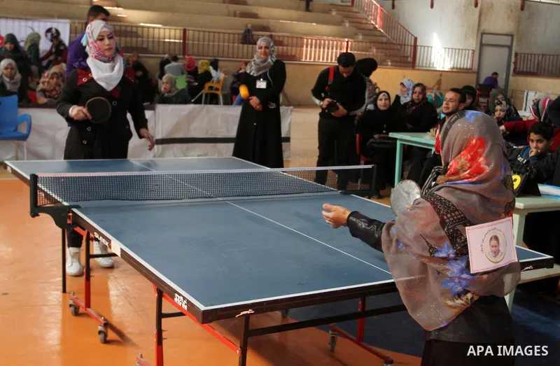 Disabled Palestinians play table tennis during the second Rachel Corrie Championship in Khan Younis in the southern Gaza strip on Dec. 30, 2015. Corrie, an American activist for the International Solidarity Movement (ISM...