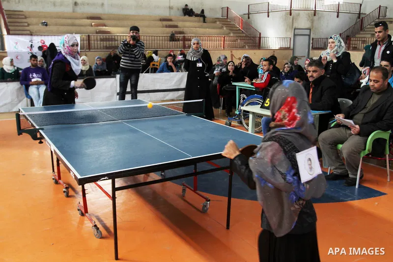 Disabled Palestinians play table tennis during the second Rachel Corrie Championship in Khan Younis in the southern Gaza strip on Dec. 30, 2015. Corrie, an American activist for the International Solidarity Movement (ISM...