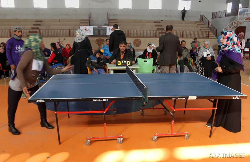 Disabled Palestinians play table tennis during the second Rachel Corrie Championship in Khan Younis in the southern Gaza strip on Dec. 30, 2015. Corrie, an American activist for the International Solidarity Movement (ISM...