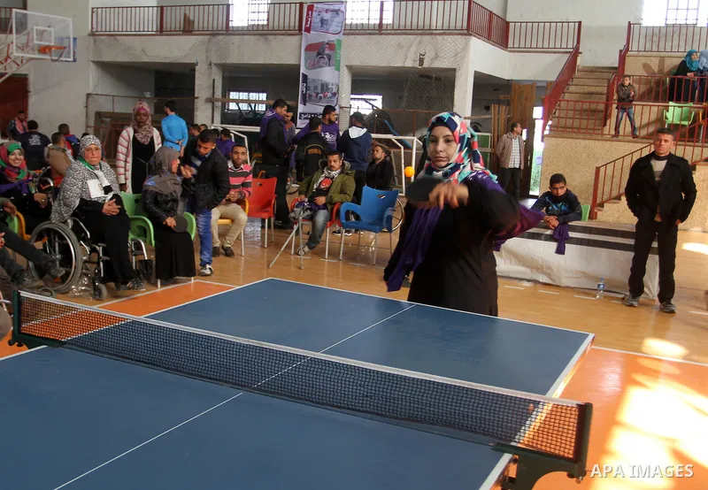 Disabled Palestinians play table tennis during the second Rachel Corrie Championship in Khan Younis in the southern Gaza strip on Dec. 30, 2015. Corrie, an American activist for the International Solidarity Movement (ISM...