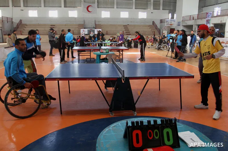 Disabled Palestinians play table tennis during the second Rachel Corrie Championship in Khan Younis in the southern Gaza strip on Dec. 30, 2015. Corrie, an American activist for the International Solidarity Movement (ISM...
