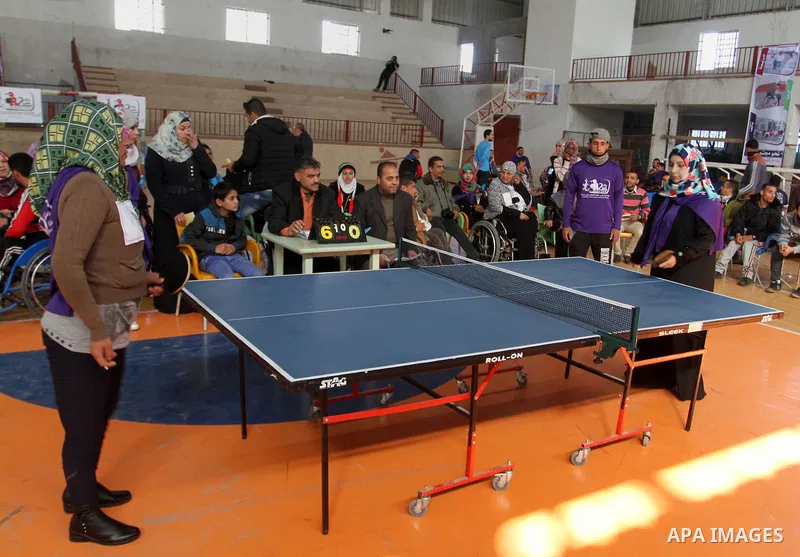 Disabled Palestinians play table tennis during the second Rachel Corrie Championship in Khan Younis in the southern Gaza strip on Dec. 30, 2015. Corrie, an American activist for the International Solidarity Movement (ISM...