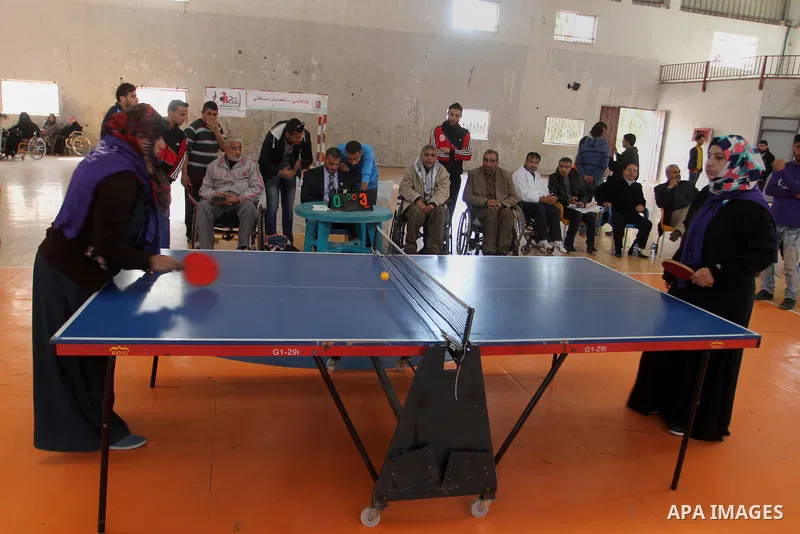 Disabled Palestinians play table tennis during the second Rachel Corrie Championship in Khan Younis in the southern Gaza strip on Dec. 30, 2015. Corrie, an American activist for the International Solidarity Movement (ISM...