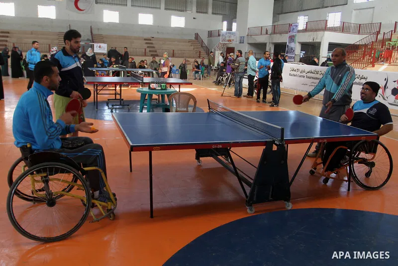 Disabled Palestinians play table tennis during the second Rachel Corrie Championship in Khan Younis in the southern Gaza strip on Dec. 30, 2015. Corrie, an American activist for the International Solidarity Movement (ISM...