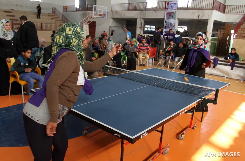 Disabled Palestinians play table tennis during the second Rachel Corrie Championship in Khan Younis in the southern Gaza strip on Dec. 30, 2015. Corrie, an American activist for the International Solidarity Movement (ISM...