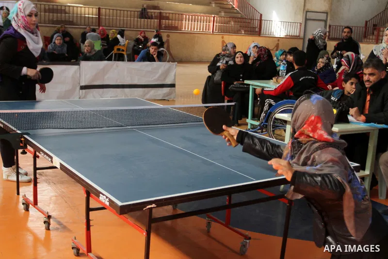 Disabled Palestinians play table tennis during the second Rachel Corrie Championship in Khan Younis in the southern Gaza strip on Dec. 30, 2015. Corrie, an American activist for the International Solidarity Movement (ISM...